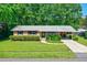 Charming single-story brick home with mature landscaping and a covered carport, surrounded by lush trees at 7 Plainfield Dr, Charleston, SC 29407