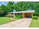 Charming brick home with a well-manicured lawn, mature landscaping, and a covered carport at 7 Plainfield Dr, Charleston, SC 29407
