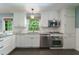 Updated kitchen with stainless steel appliances, white cabinetry, and granite countertops for a sleek look at 7 Plainfield Dr, Charleston, SC 29407