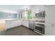 Well-lit kitchen with stainless steel appliances, white cabinets, and a tile backsplash for a modern touch at 7 Plainfield Dr, Charleston, SC 29407