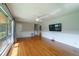Spacious living room with hardwood floors, large windows, and a wall-mounted TV for entertainment at 7 Plainfield Dr, Charleston, SC 29407