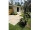 Landscaped backyard with concrete patio, privacy fence, and a variety of green plants at 702 N N Palmetto St, Summerville, SC 29483
