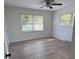 Bright bedroom featuring updated floors, two windows, and neutral walls at 702 N N Palmetto St, Summerville, SC 29483