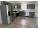 Bright kitchen featuring stainless steel appliances and light gray cabinets at 702 N N Palmetto St, Summerville, SC 29483