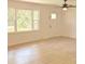Light filled living room with updated floors and a traditional ceiling fan at 702 N N Palmetto St, Summerville, SC 29483