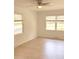 Bright living room featuring wood-look floors, neutral walls, ceiling fan, and double-paned windows at 702 N N Palmetto St, Summerville, SC 29483