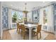 Bright dining room features a white table, woven chairs, and a cozy built-in bench at 727 Breakers Reef Ln, Huger, SC 29450