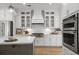 Modern kitchen with white cabinetry, stainless steel appliances, and a central island at 727 Breakers Reef Ln, Huger, SC 29450