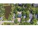 Aerial view of a home near a pond, showcasing its dark roof and surrounding trees at 817 Cheehaw St, Edisto Island, SC 29438