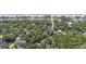 A scenic aerial view captures a house nestled among trees near a beach, marked with a yellow pin for location at 817 Cheehaw St, Edisto Island, SC 29438