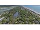 An aerial captures the home location near the ocean and marsh and showcases a beautiful area, marked with a yellow pin at 817 Cheehaw St, Edisto Island, SC 29438