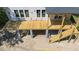 Aerial view of a new construction with a spacious wooden deck and stairs at 817 Cheehaw St, Edisto Island, SC 29438