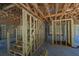 Partially framed basement space with exposed wooden staircase, offering potential for customization and expansion at 817 Cheehaw St, Edisto Island, SC 29438