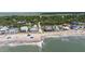 Picturesque beach view with beach houses, sandy shoreline, and ocean in the background at 817 Cheehaw St, Edisto Island, SC 29438