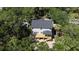 Aerial view of a new house under construction, showcasing back deck and roof design amidst trees at 817 Cheehaw St, Edisto Island, SC 29438