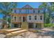 An unfinished two-story beach house is elevated on stilts with a wooden staircase and surrounded by tropical foliage at 817 Cheehaw St, Edisto Island, SC 29438