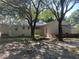 Exterior back view of home with brick details, mature trees, and AC unit at 874 Evans Rd, Charleston, SC 29412