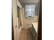 Bathroom featuring vintage fixtures, a window with curtains, and tiled walls at 874 Evans Rd, Charleston, SC 29412