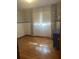 Empty bedroom with hardwood floors, a large window with curtains and blue accents at 874 Evans Rd, Charleston, SC 29412