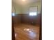A secondary bedroom with wood paneled walls, hardwood floors, and natural light from the windows at 874 Evans Rd, Charleston, SC 29412