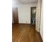 Bedroom with hardwood floors, floral curtains, and attached full bathroom at 874 Evans Rd, Charleston, SC 29412