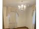 Bright bedroom featuring a chandelier and custom window treatments at 874 Evans Rd, Charleston, SC 29412