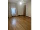 Bedroom featuring hardwood floors, floral curtains, and a view of the hall bathroom at 874 Evans Rd, Charleston, SC 29412