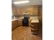 Functional kitchen with wood cabinets, black appliances, and a peninsula with shelving at 874 Evans Rd, Charleston, SC 29412