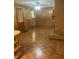 Spacious living area featuring wood-paneled walls, hardwood floors, and a brick fireplace at 874 Evans Rd, Charleston, SC 29412