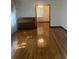 Living room with hardwood floors, piano, and light streaming through the windows at 874 Evans Rd, Charleston, SC 29412