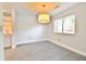 This dining room features a modern pendant light, neutral tile flooring, and a large window, with an adjacent kitchen area at 93 Ashley Hall Plantation Rd # 6, Charleston, SC 29407