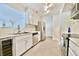 Well-lit kitchen featuring white cabinets, stainless steel appliances, marble countertops, and tile flooring for a modern aesthetic at 93 Ashley Hall Plantation Rd # 6, Charleston, SC 29407