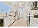 Well-lit kitchen featuring white cabinets, stainless steel appliances, marble countertops, and tile flooring for a modern aesthetic at 93 Ashley Hall Plantation Rd # 6, Charleston, SC 29407