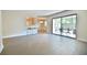 Spacious living room with tiled floors, breakfast bar, and sliding glass doors to a patio at 93 Ashley Hall Plantation Rd # 6, Charleston, SC 29407
