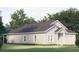 Beautiful home featuring white siding, a two-car garage, manicured lawn, and lush trees at Blvd, Moncks Corner, SC 29461