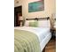 Comfortable bedroom with crisp white linens and sage green throw and accent pillow at 10 Riker St, Charleston, SC 29403