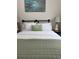 Bright bedroom with a green quilt, white sheets, and an artistic wall hanging at 10 Riker St, Charleston, SC 29403