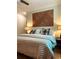 Comfortable bedroom with a geometric wood accent wall and parquet floors at 10 Riker St, Charleston, SC 29403
