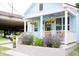 Charming exterior of home with light blue siding, white trim, and flowering plants at 10 Riker St, Charleston, SC 29403