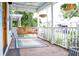 Inviting front porch with a swing, hanging plants, and charming details at 10 Riker St, Charleston, SC 29403