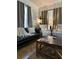 Inviting living room features a black leather sofa and two chairs, perfect for relaxing at 10 Riker St, Charleston, SC 29403