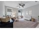 Cozy Bedroom with neutral tones, ceiling fan, comfy recliner, a white crib, and a patterned rug for a warm, inviting feel at 1052 Avenue Of Oaks, Charleston, SC 29407