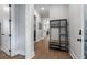 Hallway with hardwood floors, coat rack, and white trim at 1052 Avenue Of Oaks, Charleston, SC 29407
