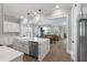 Open-concept kitchen with a central island, modern appliances, and a view into the dining and living areas at 1052 Avenue Of Oaks, Charleston, SC 29407