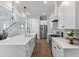 Modern kitchen with stainless steel appliances, a large island with a sink, and white cabinets at 1052 Avenue Of Oaks, Charleston, SC 29407