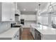 Bright kitchen featuring stainless steel appliances, white cabinets, an island, and hardwood floors at 1052 Avenue Of Oaks, Charleston, SC 29407