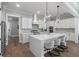 Modern kitchen featuring white cabinets, marble backsplash, a center island, and pendant lighting at 1052 Avenue Of Oaks, Charleston, SC 29407