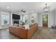 Comfortable living room boasts a brick fireplace and an extra-large sectional sofa for cozy relaxation at 1052 Avenue Of Oaks, Charleston, SC 29407