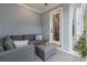 Comfortable screened porch area with a grey sectional and indoor/outdoor carpet at 1052 Avenue Of Oaks, Charleston, SC 29407