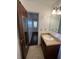 Bathroom with single vanity and tile flooring, doorway leads to an adjacent room at 1056 Yorktown Dr, Charleston, SC 29412